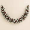 White flocked artificial pine garland with berry clusters and pine cones on an ivory background
