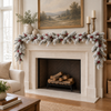 White flocked pine garland with berries and pine cones draped across a neutral mantel